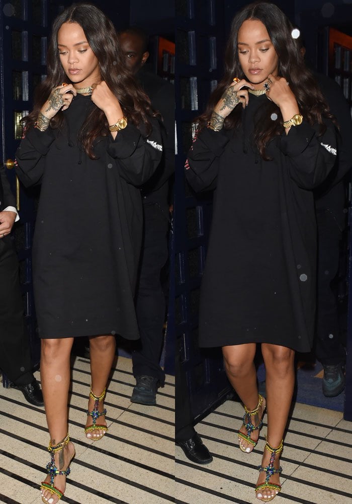 Rihanna wears a black hoodie dress from Vetements as she leaves a London club