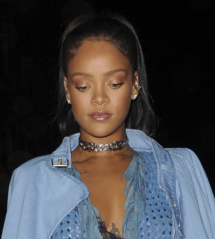 Rihanna wears a silver metallic choker with a Balmain denim coat