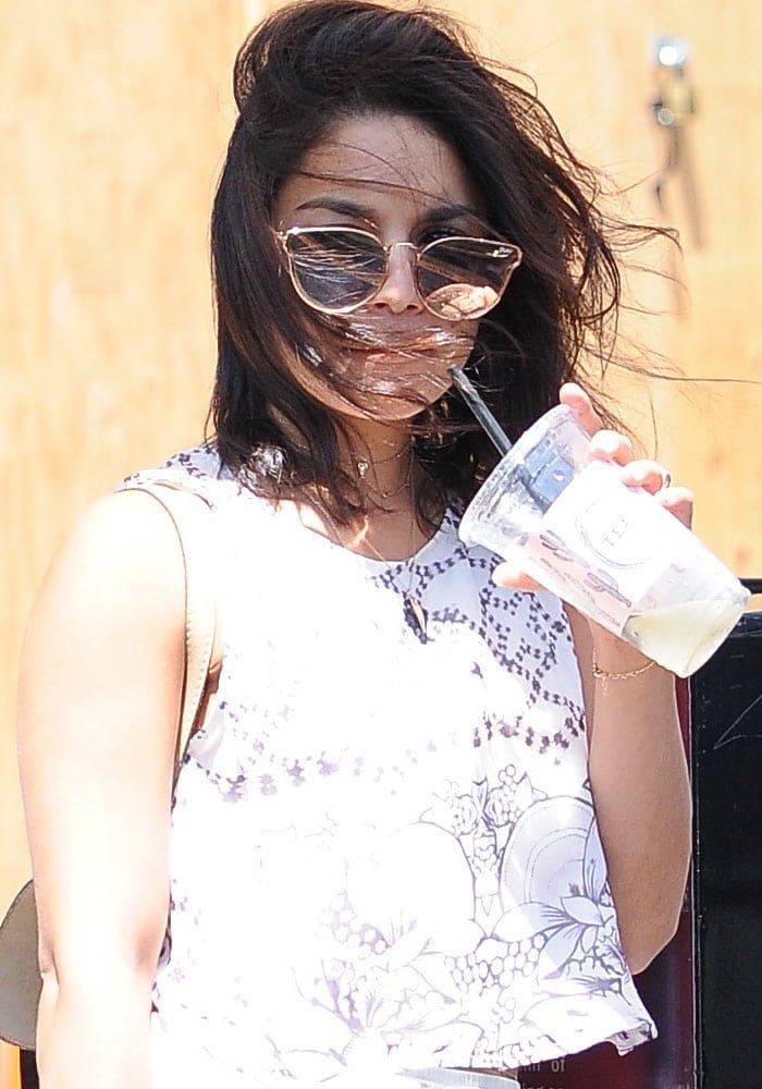 Vanessa Hudgens's hair blows in the wind as she waits for her car after a shopping trip