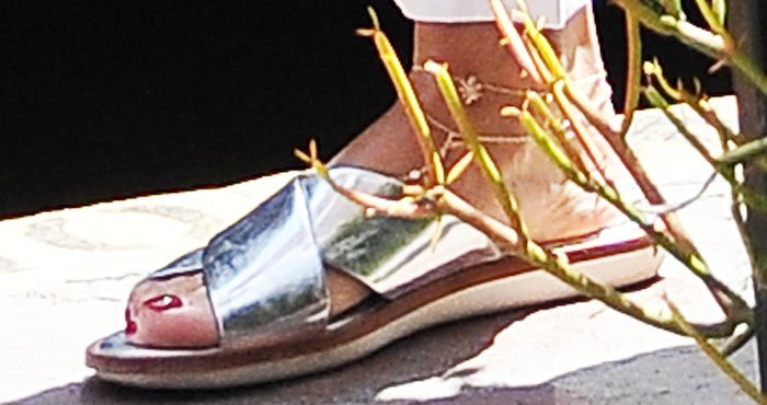 Vanessa Hudgens's feet in silver metallic Louise et Cie slide sandals