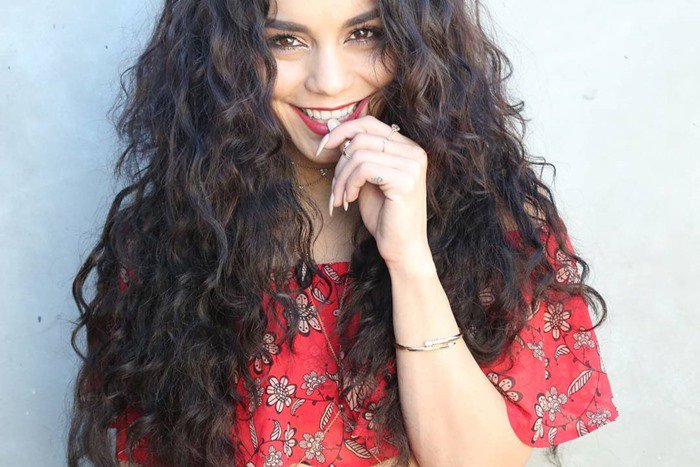 Vanessa Hudgens with tousled beachy waves in a For Love & Lemons crop top with a Pave Black Agate Arrowhead necklace and 5 Diamond bodychain by Jacquie Aiche