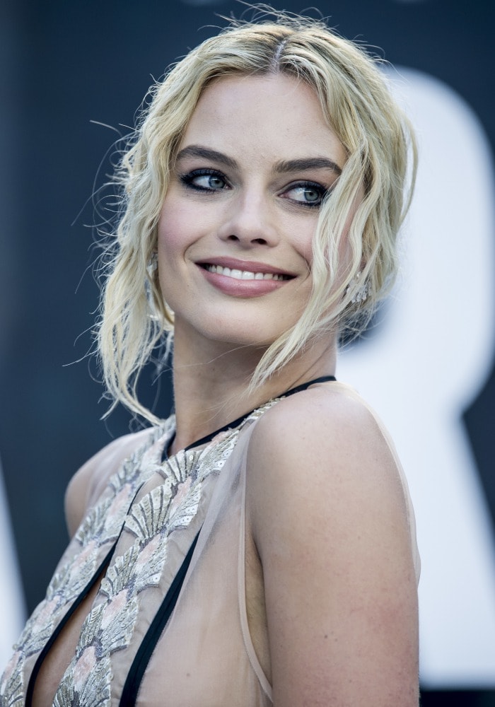 Margot Robbie's soft blonde curls and dazzling diamond accessories added a touch of glamour to her overall look