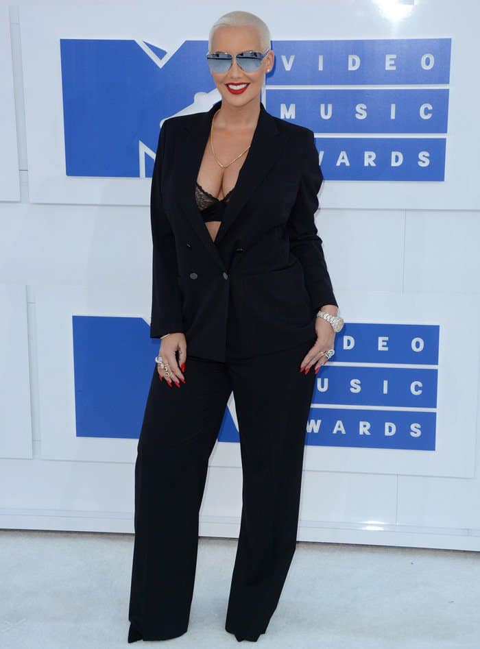 Amber Rose hides her Dior pumps underneath her Tom Ford suit pants