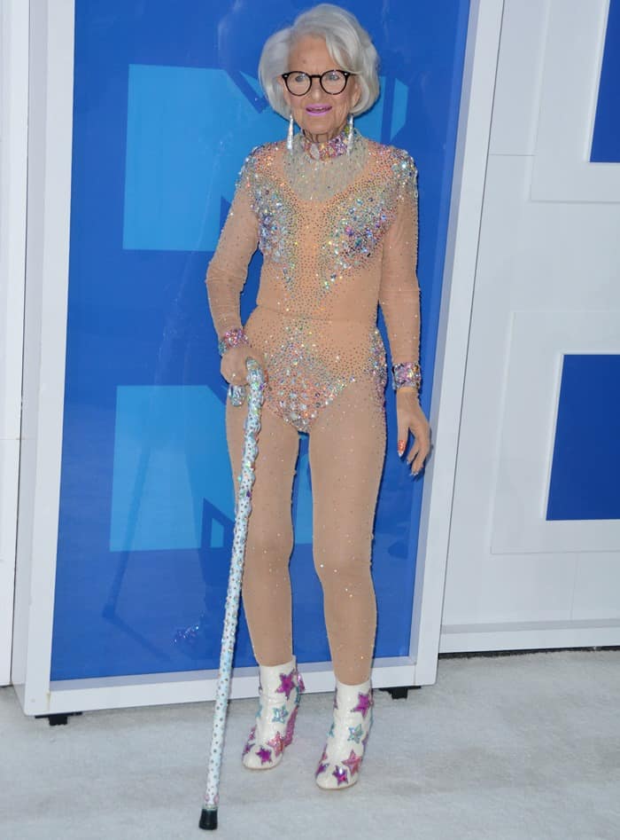 Baddie Winkle carries a bedazzled cane to accompany her jewel-embellished nude bodysuit