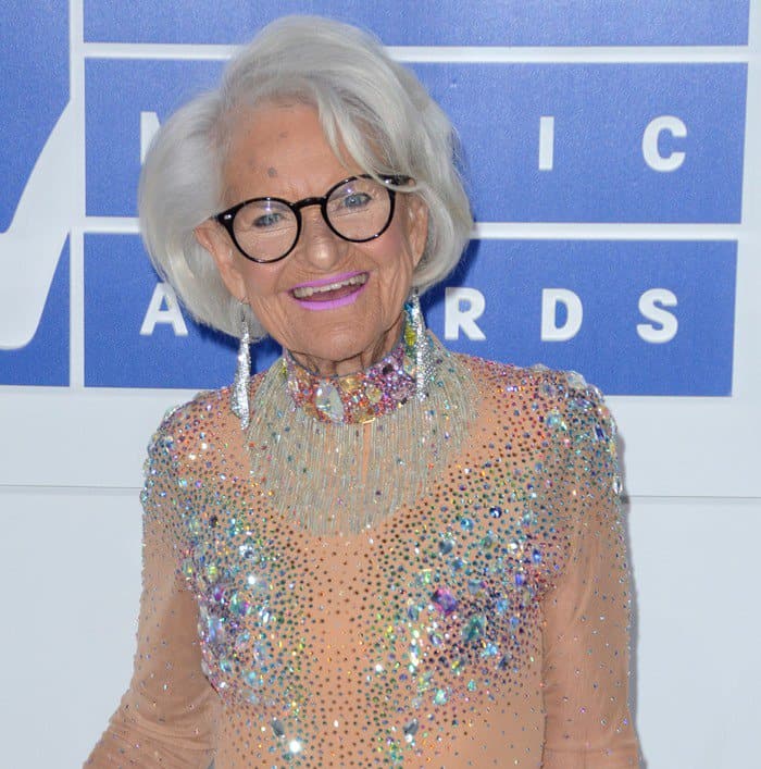Baddie Winkle wears a jewel-embellished nude bodysuit with a high neckline and multi-colored crystals placed across the chest and shoulders to the MTV VMAs