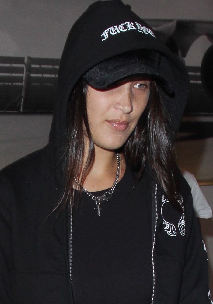 Bella Hadid covered her hair with a hat and a hood as she arrived at the Los Angeles International Airport