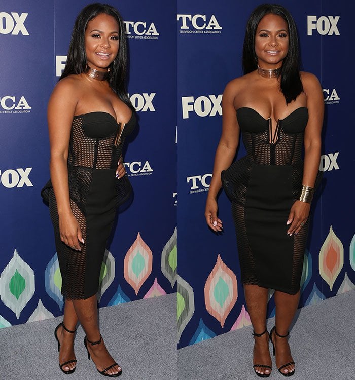 Christina Milian poses on the blue carpet in a cleavage-baring peplum dress from Lexi Clothing