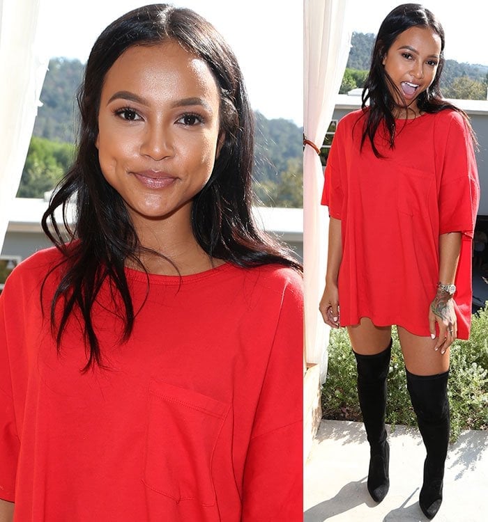 Karrueche Tran wears a baggy red shirtdress with thigh-high black boots