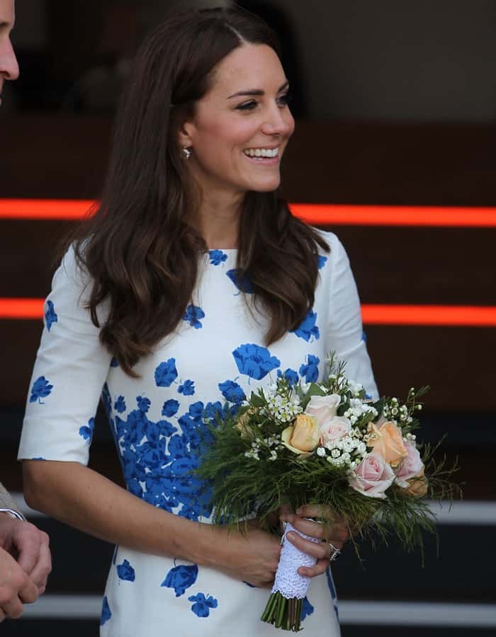 Kate Middleton beams with grace in her L.K. Bennett floral dress while holding a bouquet
