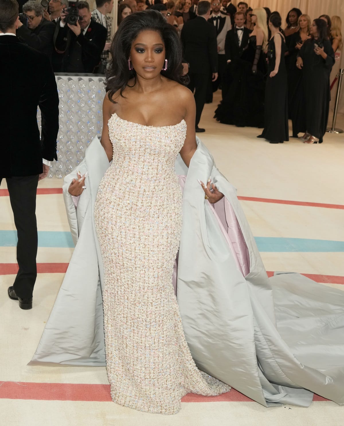 Keke Palmer exuded glamour in a strapless pastel tweed gown designed by Sergio Hudson adorned with over 12,000 Swarovski crystals and pearls at the 2023 Met Gala