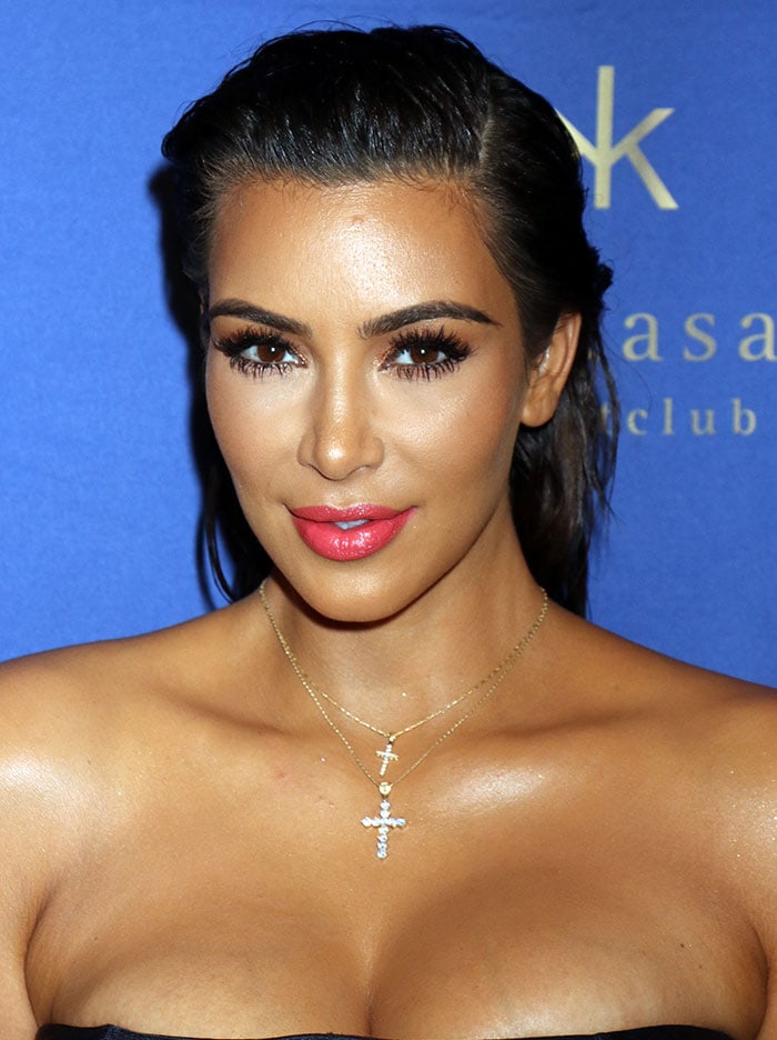 Kim Kardashian sported pink lipstick and wore her hair in a slicked-back style