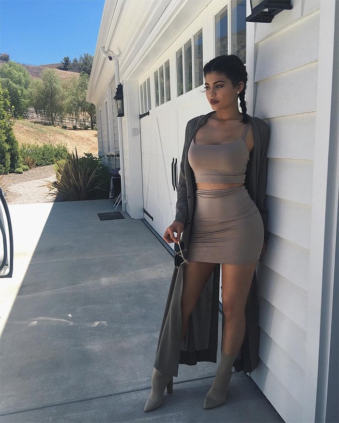 Kylie Jenner's Instagram posts of her monochromatic beige ensemble consisting of a Naked Wardrobe Walkin Thin Lines crop top and miniskirt set and Yeezy season 2 knit booties