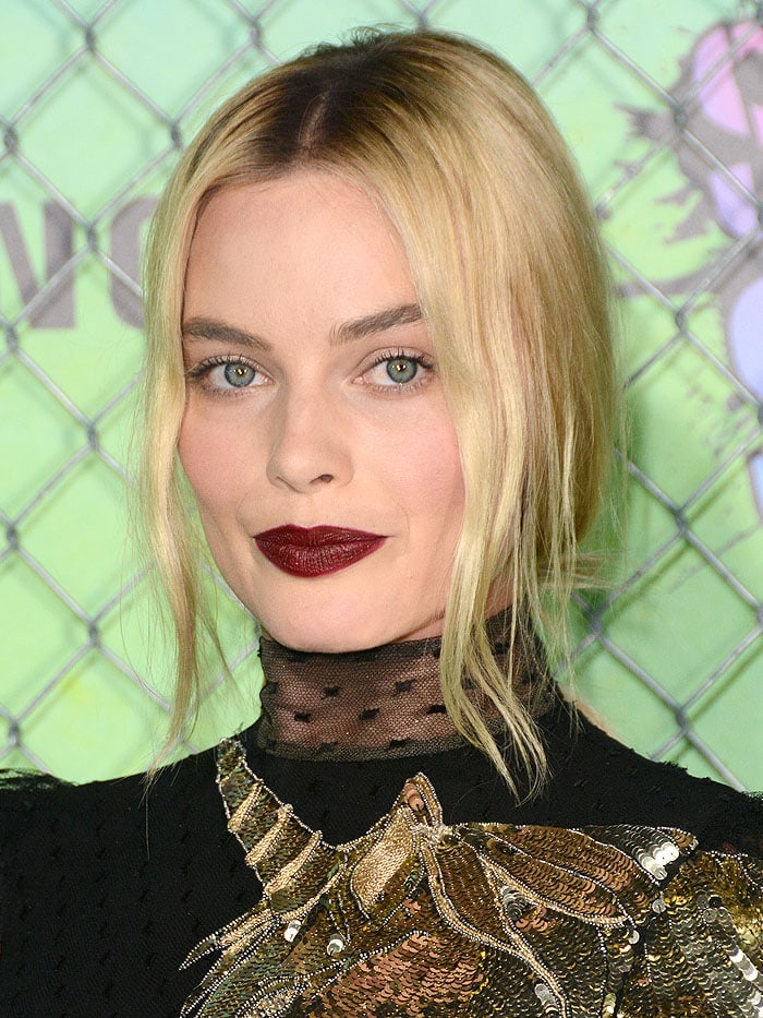 Margot Robbie completed her look with a dark red lip and an up-do paying homage to her character Harley Quinn in the film