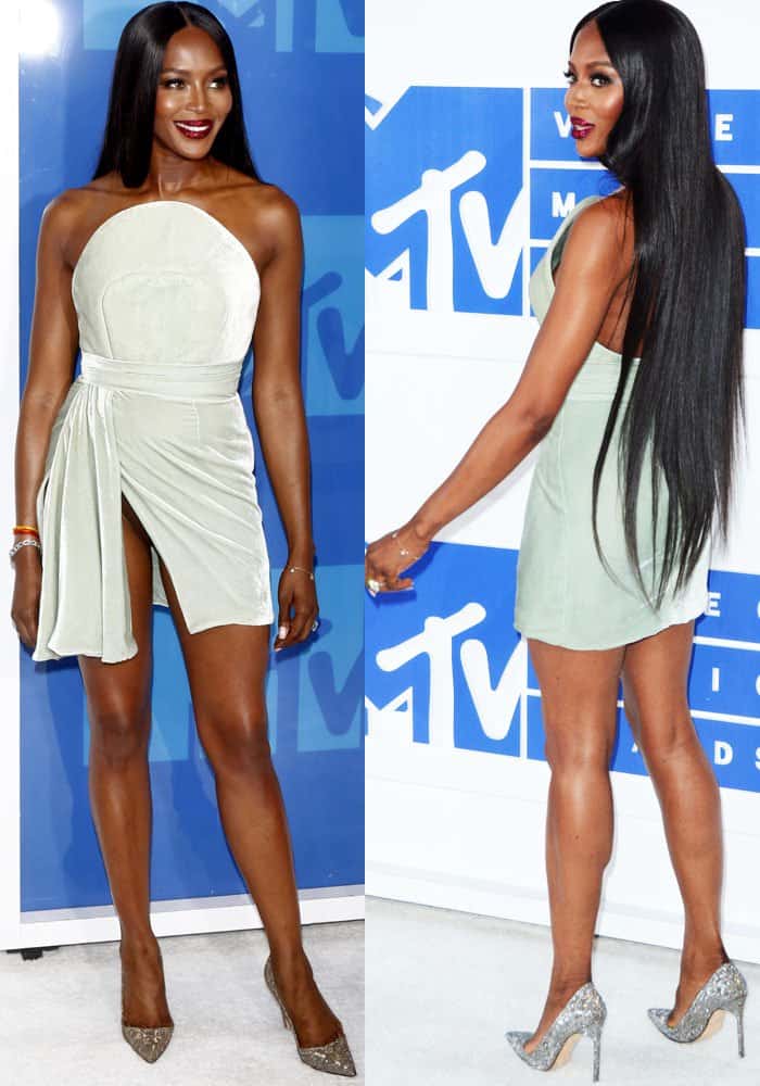 Naomi Campbell shows off her legs and underwear in a short velvet Brandon Maxwell dress