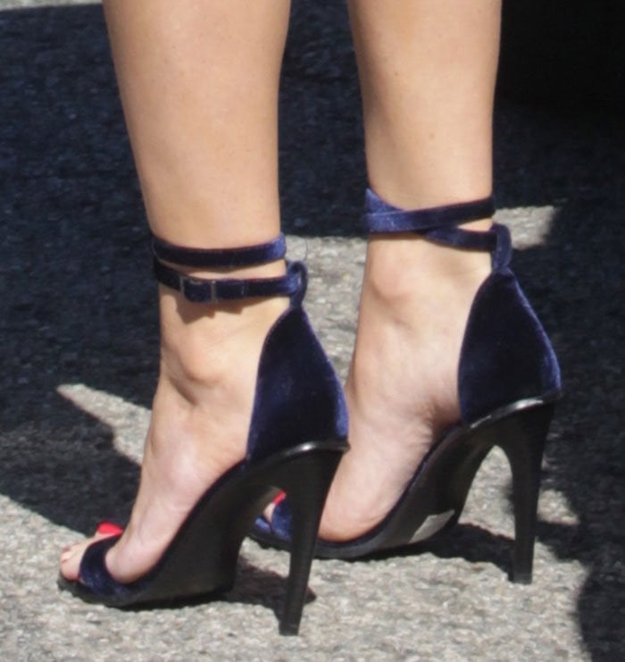 Olivia Munn wearing navy velvet sandals