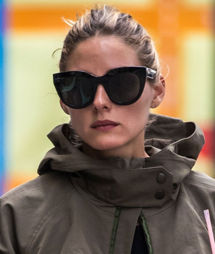 Olivia Palermo wears her hair back in a standout green mixed media jacket by Moncler