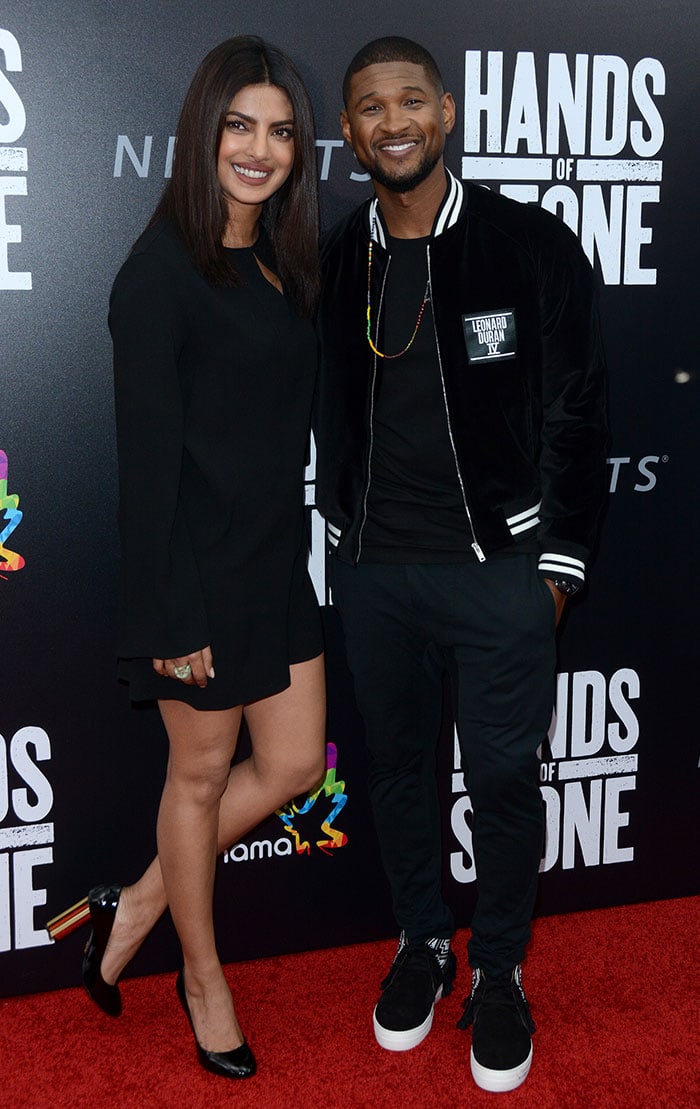 Priyanka Chopra and Usher pose for photos on the red carpet of the "Hands of Stone" premiere