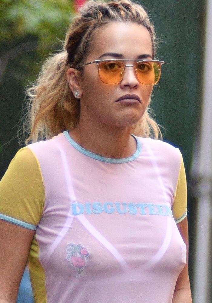 Rita Ora twists her hair back and showcases her boobs in a sheer, pastie-revealing t-shirt