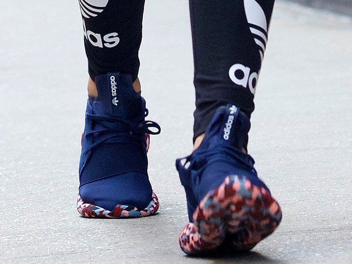 Rita Ora wears her own Rita Ora x Adidas Originals "Tubular Defiant" sneakers from the "Color Paint Pack" collection