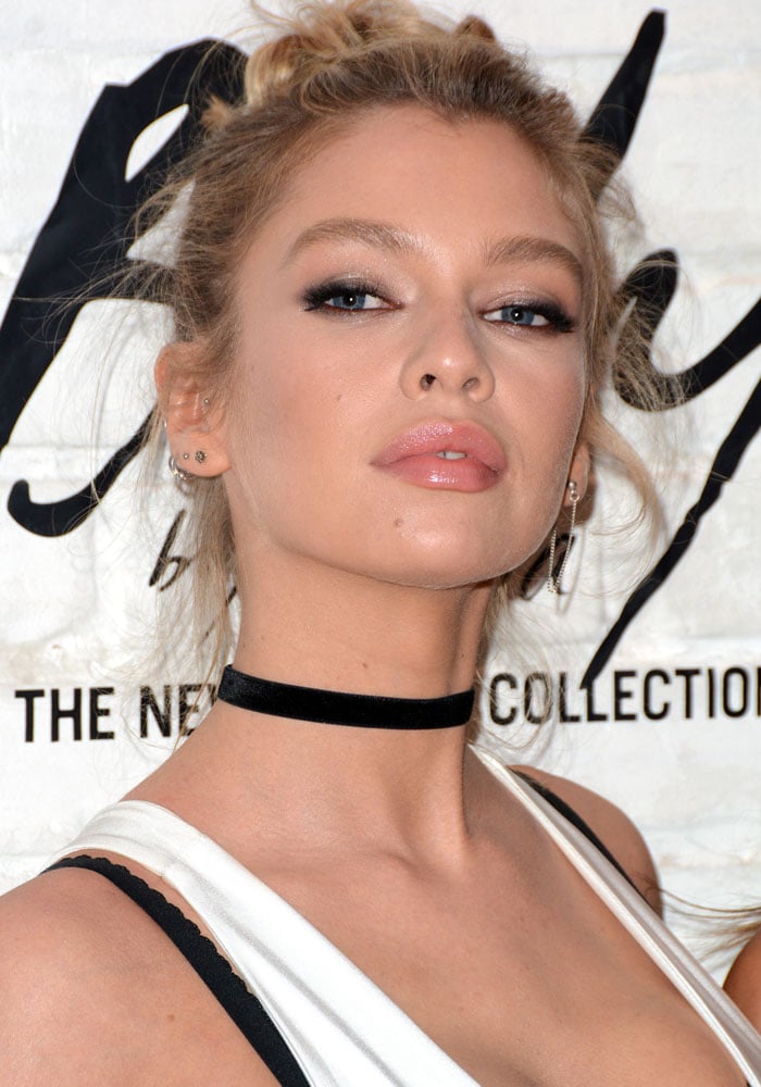 Stella Maxwell with a messy topknot bun wears a black choker at Victoria's Secret "Easy" collection launch