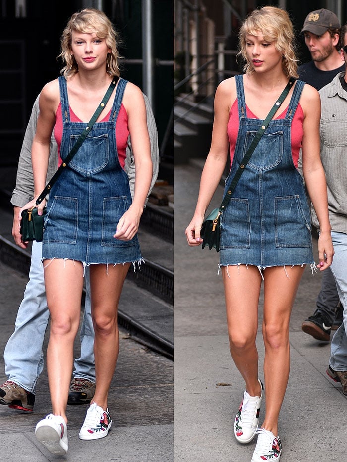 Taylor Swift layers an overall denim dress over a Brandy Melville crop tank