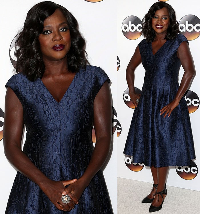 Viola Davis shows off her arms in a textured blue v-neck dress