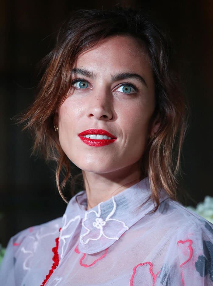 Alexa Chung's tousled brunette waves and bold red lips added a touch of modernity to the sophisticated attire