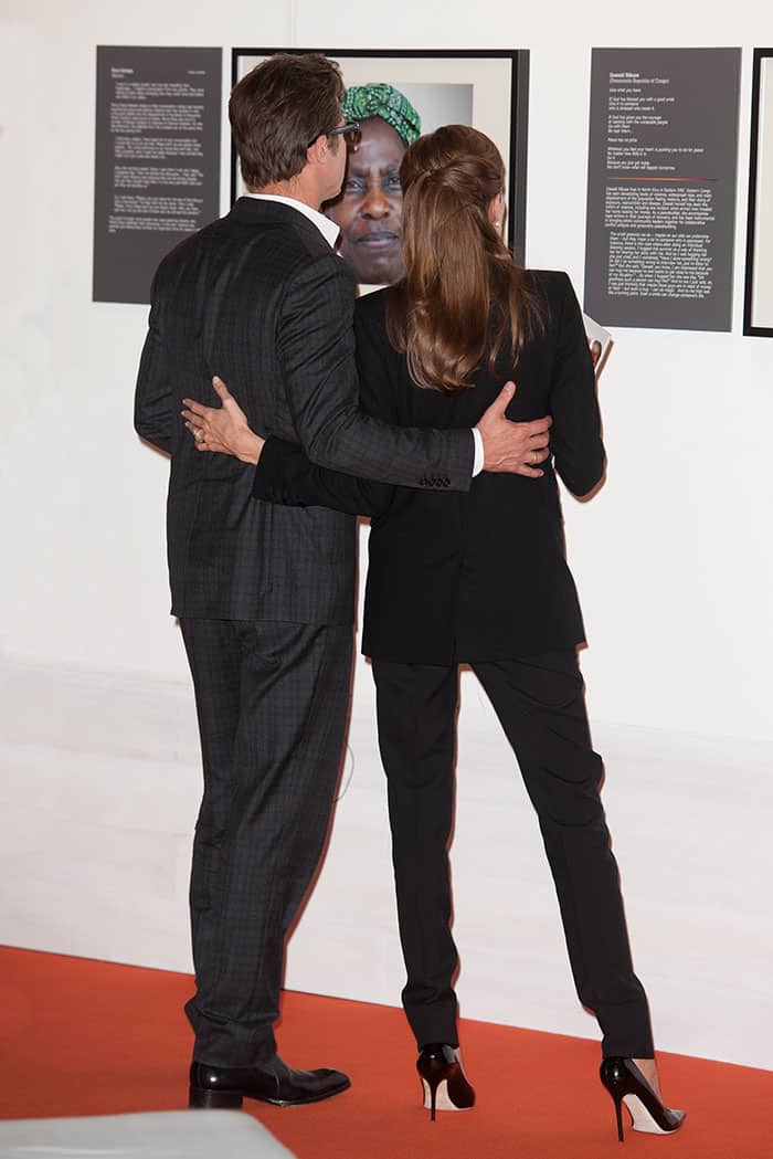 In 2014, Angelina Jolie and Brad Pitt, dressed in a coordinated black Saint Laurent suit and Jimmy Choo "Lilac" pumps, stand together at the End Sexual Violence Conference in London