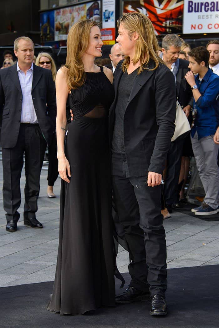 Following Angelina's double mastectomy, Brad Pitt shows immense support as Angie stuns in a black Saint Laurent gathered gown and black Saint Laurent "Janis" platform pumps at the 2013 premiere of "World War Z" in London