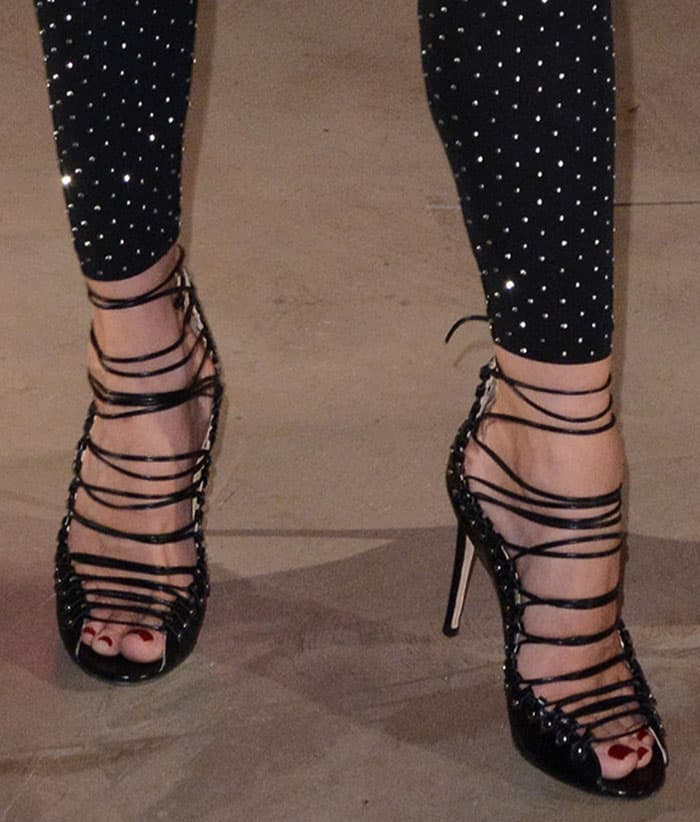 Diane Kruger showcases her elegant pedicure in Jimmy Choo's strappy 'Koko' sandals, featuring studded details and wraparound ankle ties for a bold, chic finish