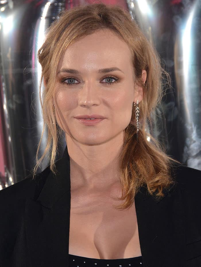 Diane Kruger complements her chic messy ponytail with elegant drop earrings