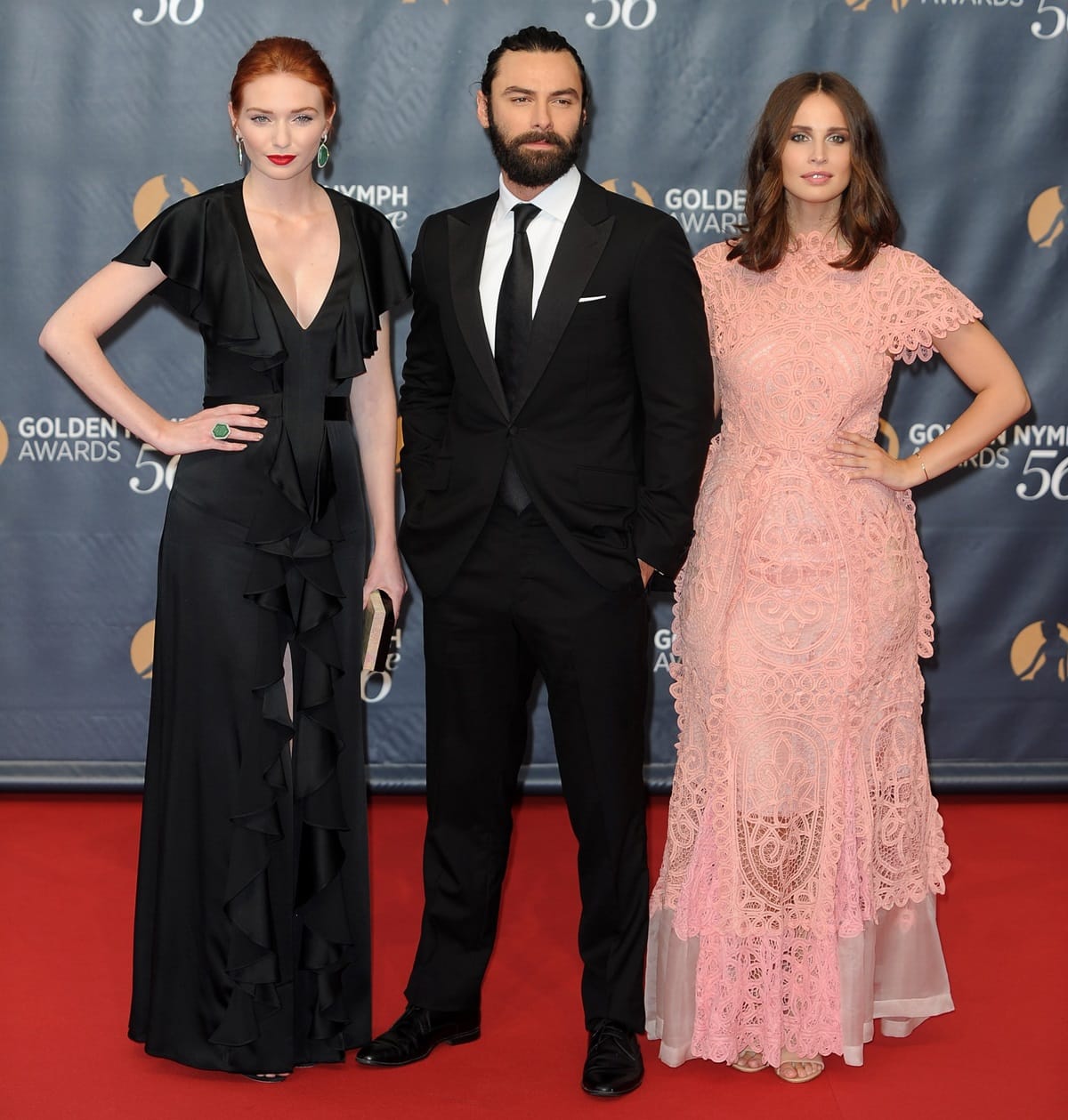 On the red carpet at the 56th Monte Carlo TV Festival Closing Ceremony and Golden Nymph Awards at The Grimaldi Forum on June 16, 2016, in Monte-Carlo, Monaco, Eleanor Tomlinson stood at 5ft 7 ½ inches (171.5 cm), Heida Reed was 5ft 7 inches (170.2 cm) tall, and Aidan Turner towered at 5ft 10 ½ inches (179.1 cm)