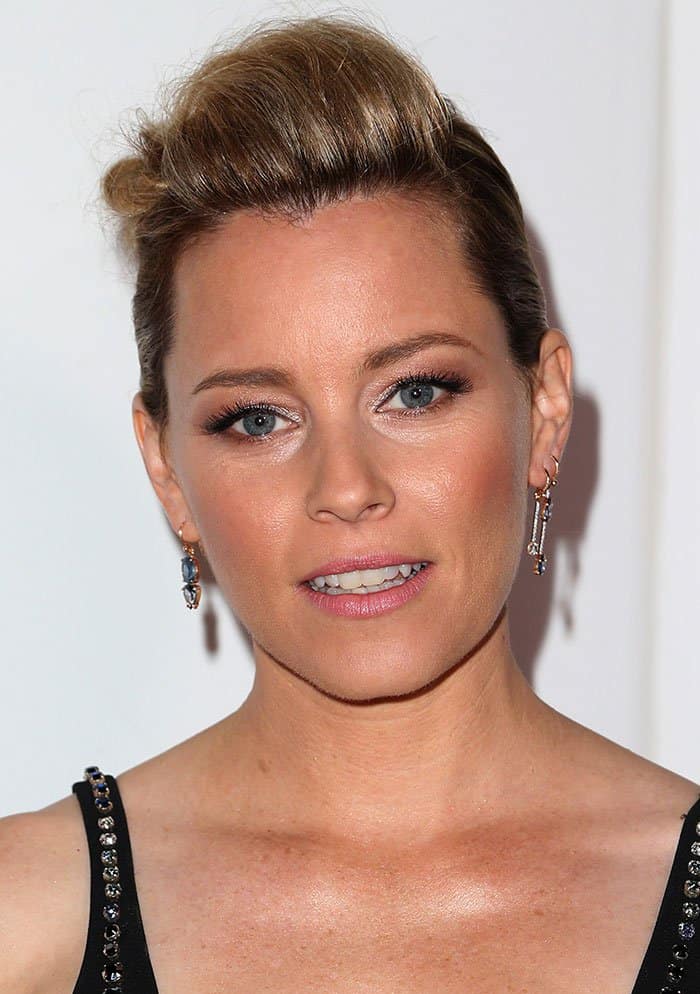 Elizabeth Banks' slicked-back hairstyle and dangling earrings