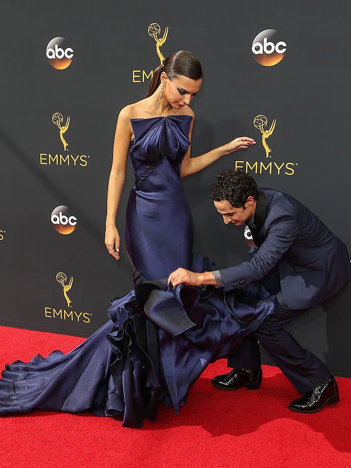 Zac Posen fixing his own Resort 2017 navy strapless gown design on Emily Ratajkowski