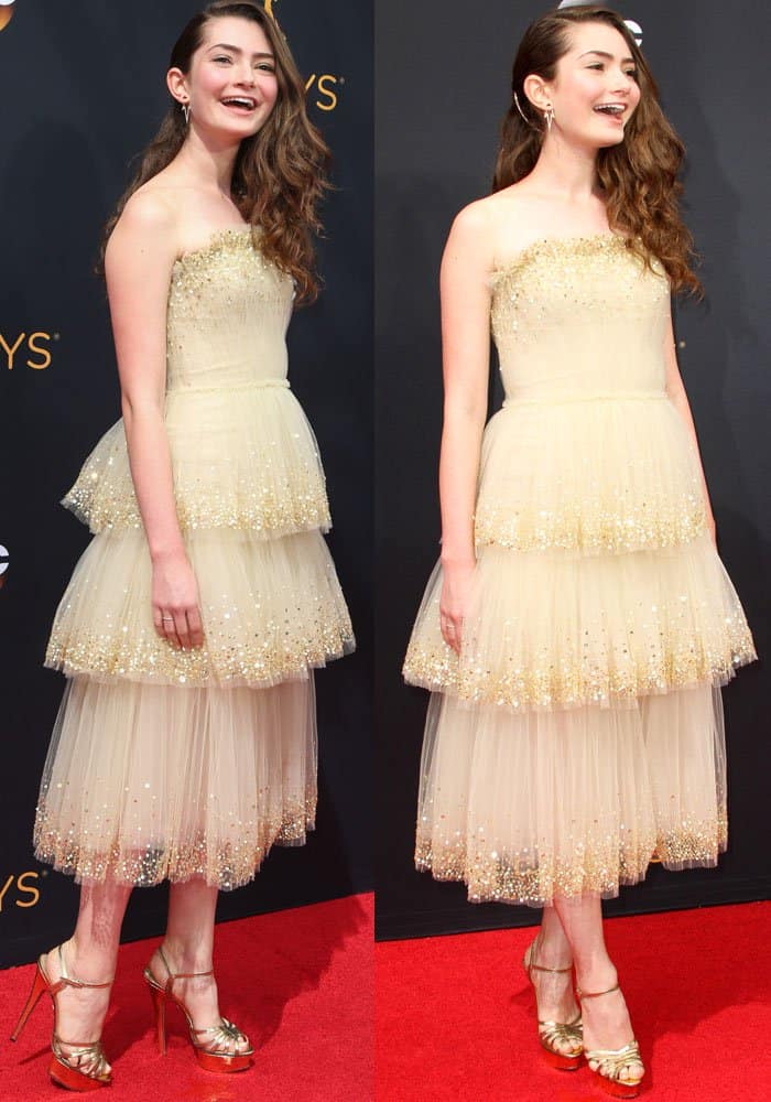 Emily Robinson elegantly donned a Carolina Herrera gown, accentuated with Charlotte Olympia heels and a bag, and complemented by exquisite jewelry from Ileana Makri