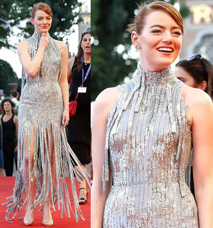 Emma Stone shines in a shimmering silver Atelier Versace gown with fringe detailing, turning heads on the red carpet at the Venice Film Festival