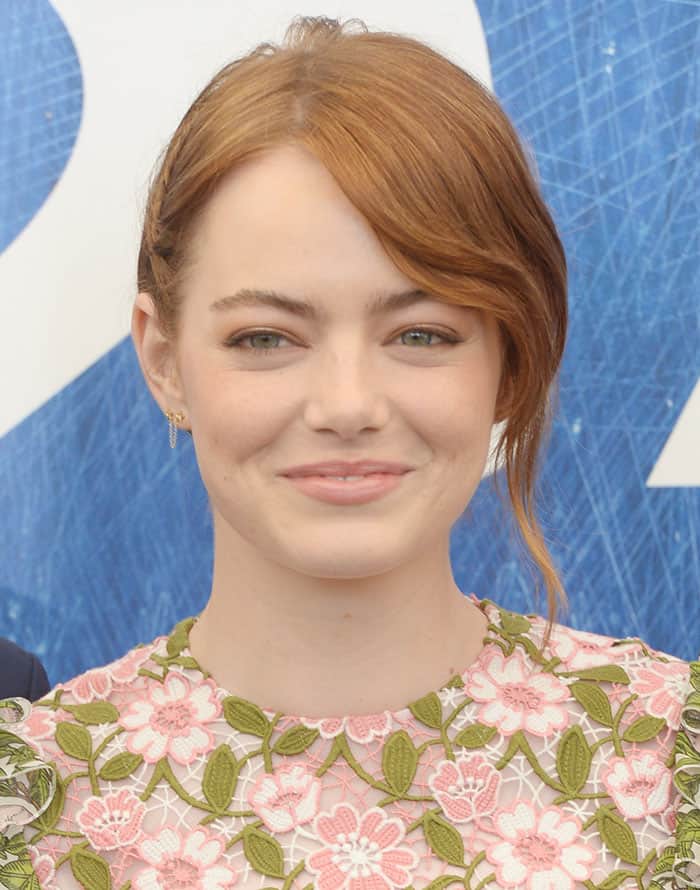 Emma Stone keeps it simple yet elegant with a delicate Jennifer Meyer earring, complementing her chic updo and side-swept bangs