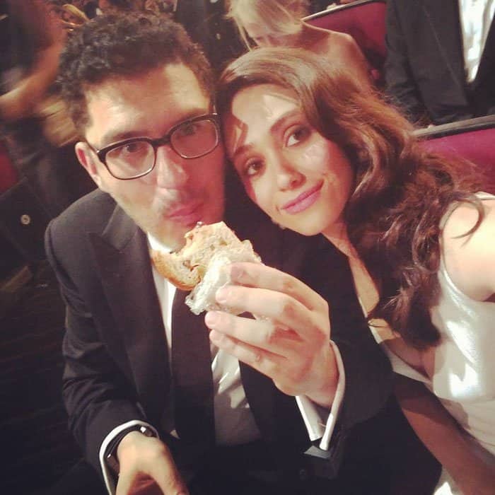 Emmy Rossum uploads a photo of her fiancé munching on a sandwich with the caption, "Thanks Jimmy's mom for the sustenance!!!!"