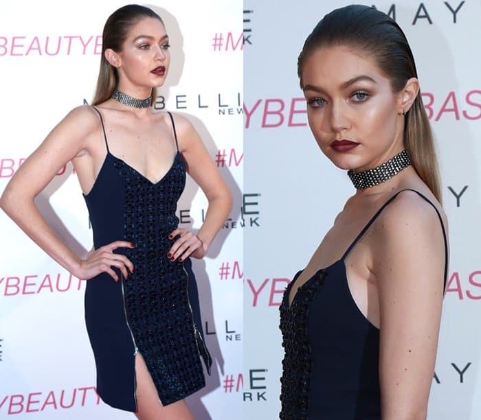 Gigi Hadid commands attention in a daring navy dress and statement choker, complete with a bold lip and sleek hairstyle, at the Maybelline New York Beauty Bash