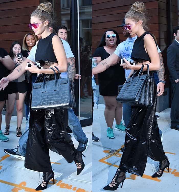 Gigi Hadid shows a midriff and laced bra in a crop Noam Hanoch Inez top and vinyl pants