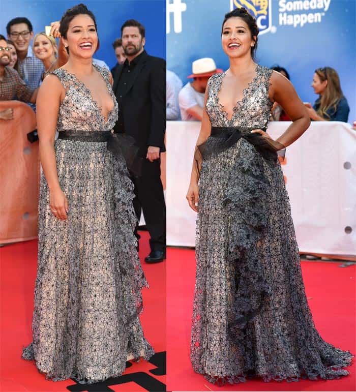 Gina Rodriguez's black and grey floral embroidered ruffled split gown featured a v-neck design, elevated by an alluring black tulle tie waist and an elegant white underlining