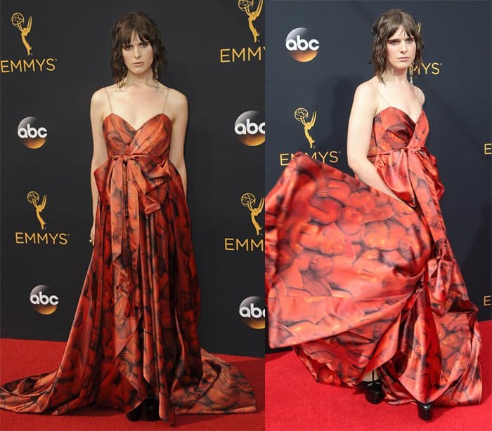 Hari Nef makes a bold statement in a vibrant red gown adorned with a striking cherub print at the 2016 Primetime Emmy Awards