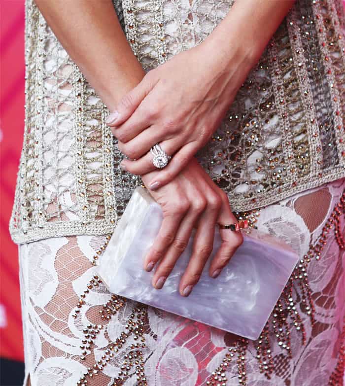 Breathtaking: Jamie Chung shows off the details of her look, which included an Edie Parker clutch, gorgeous rings, and even an embellished manicure