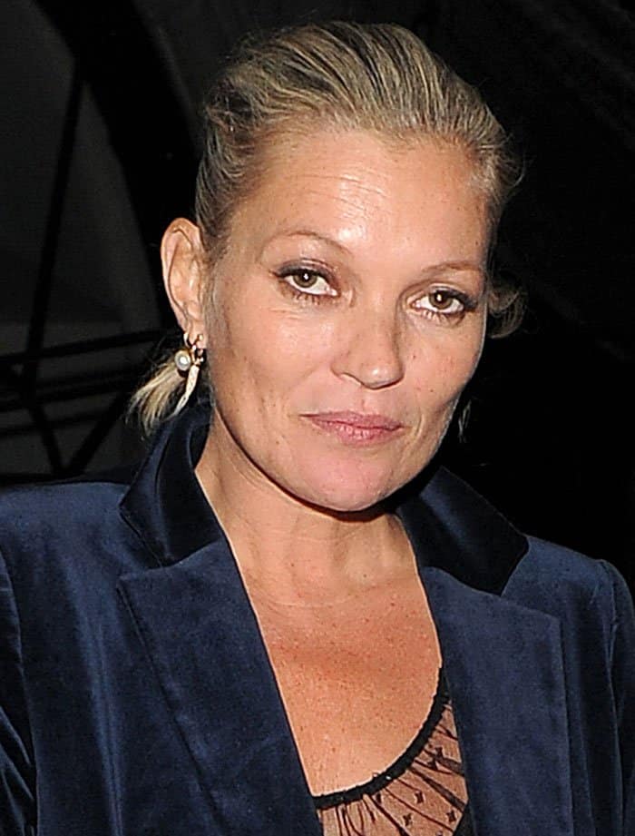 Kate Moss let her natural allure take center stage, her hair casually tied in a tousled bun