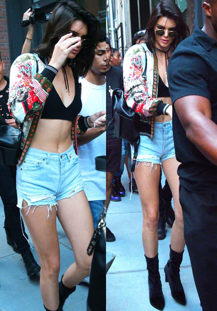 Kendall Jenner drew a crowd outside Kylie's apartment in a black bra top paired with a bomber jacket and denim shorts