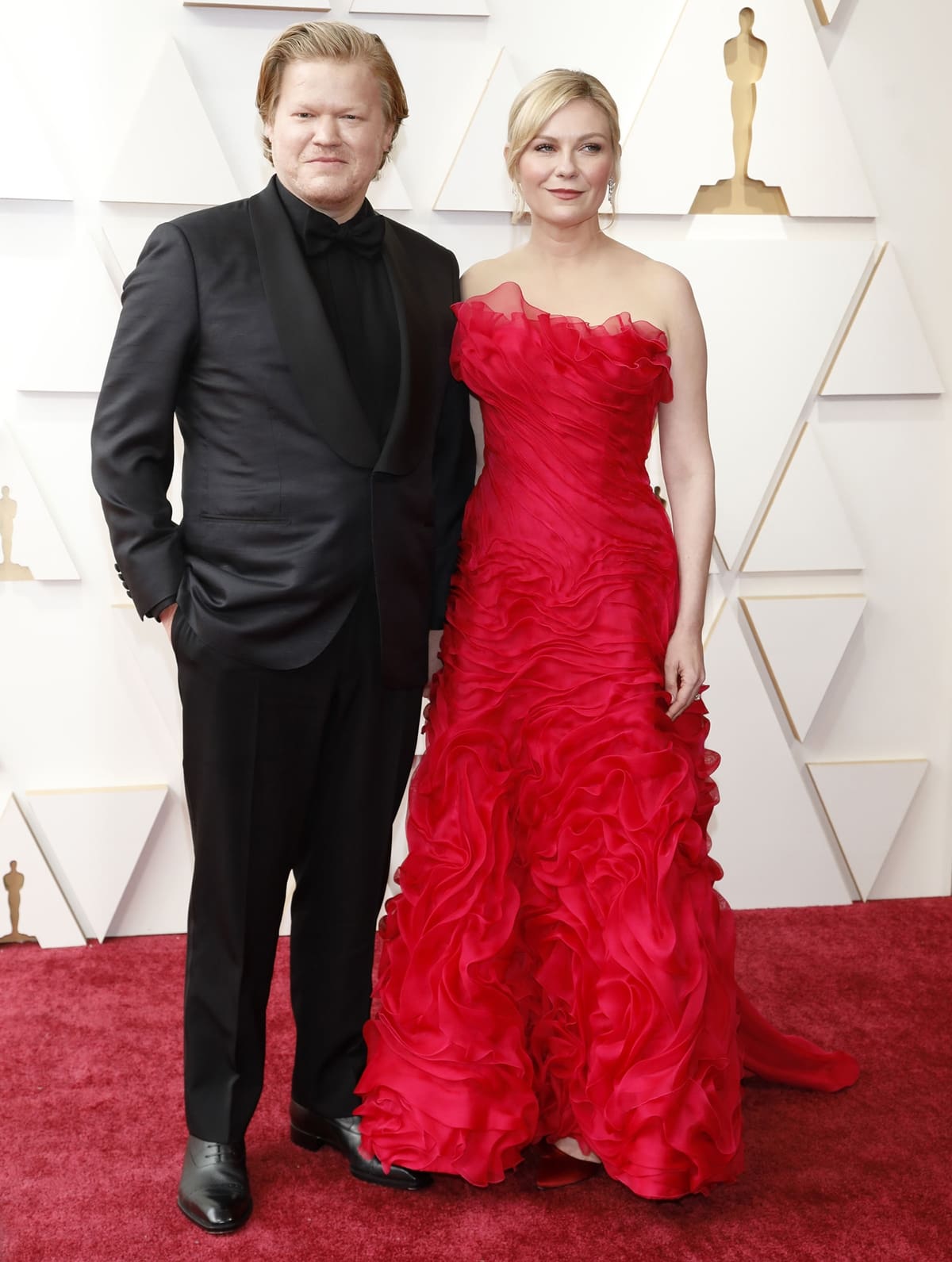Kirsten Dunst in a red vintage Christian LaCroix dress from Lily et Cie with her husband Jesse Plemons at the 94th Annual Academy Awards