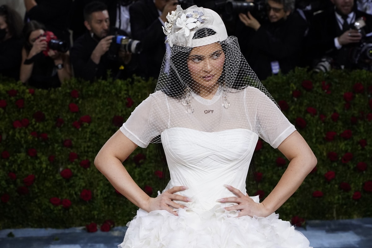 Kylie Jenner styled her custom off-white ‘Poetry Dress’ with a backwards baseball hat featuring a veil