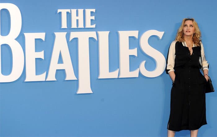 Madonna poses beside the iconic logo of The Beatles