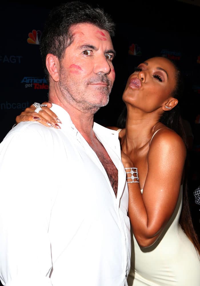 Friend or foe? Mel B gives Simon Cowell kisses before the show started