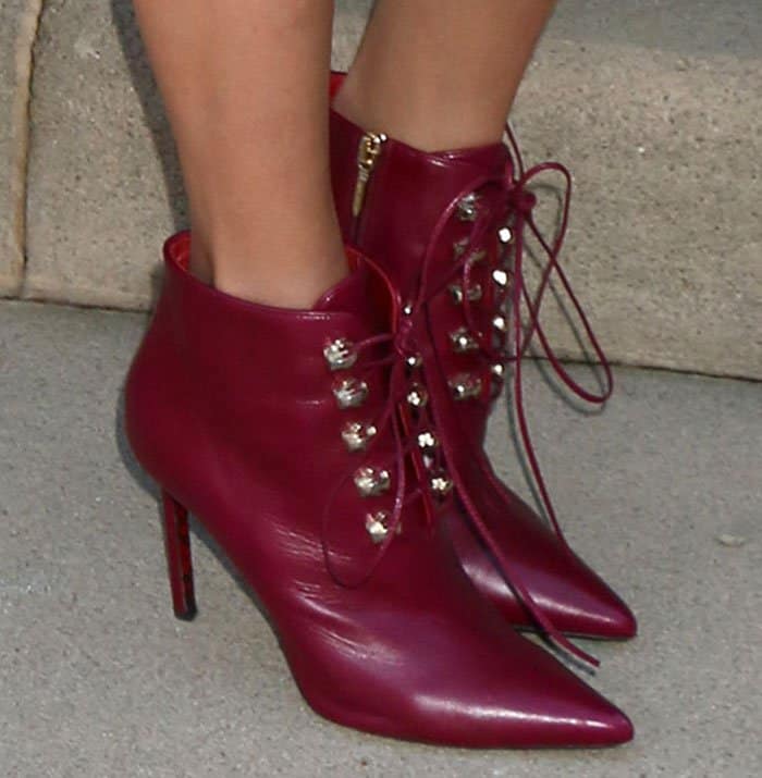 Nina Dobrev's oxford leather booties, accentuated with metal eyelets, lace-up details, pointed toes, and side zips, stood tall on about four-inch heels